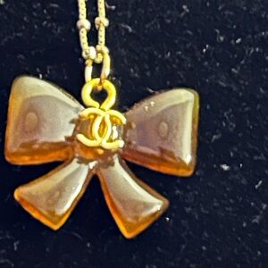 CHANEL Upcycled Gold and Brown Bow Pendant Necklace